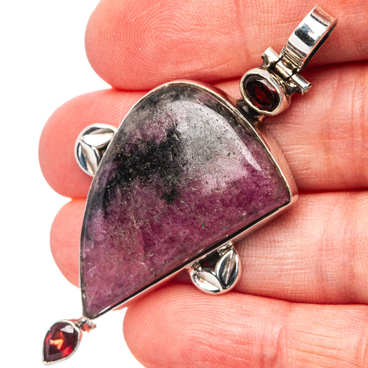 Rhodonite teardrop pendant in .925 sterling silver with red garnet accents