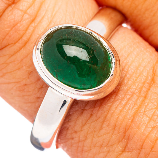 Oval green emerald set in sterling silver ring with bezel setting