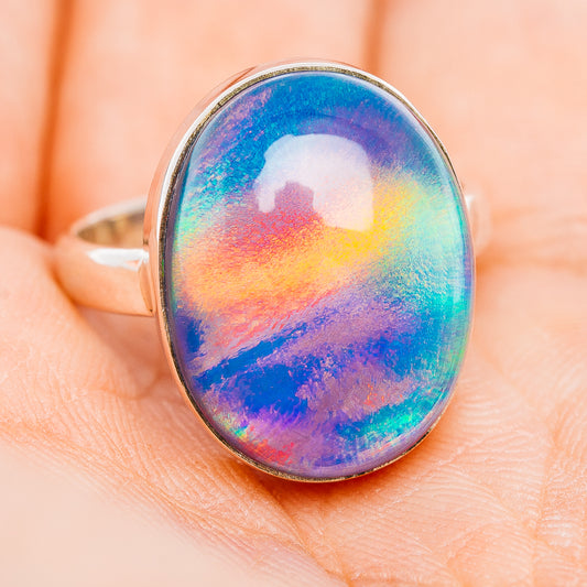 Oval opal-style gemstone ring with multicolor blue-green-red surface and polished silver band