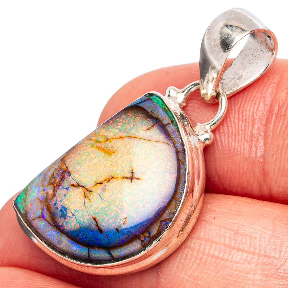 Sterling silver opal pendant with teardrop cabochon, iridescent blue and green flashes