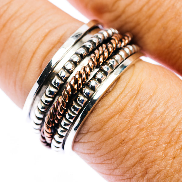 Sterling silver spinner ring with ridged spiral bands and copper-tone accents