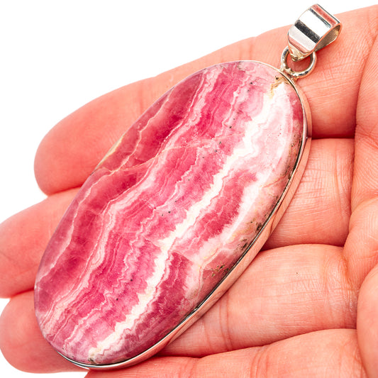 Oval rhodochrosite pendant with pink-red and white banded stone in sterling silver bezel