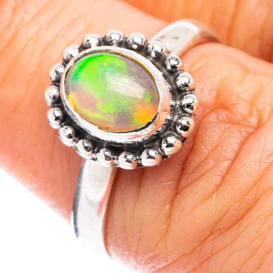 Sterling silver opal ring with green-orange Ethiopian opal center and beaded halo