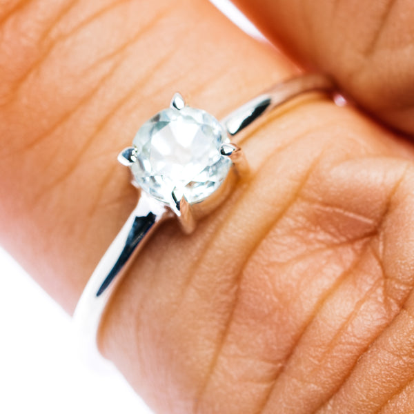 Sterling silver stackable ring with light blue round gemstone and prong setting