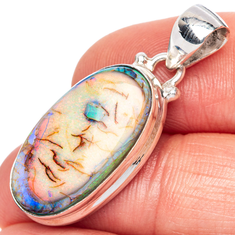 Oval 925 sterling silver opal pendant close-up with rainbow orange blue flashes