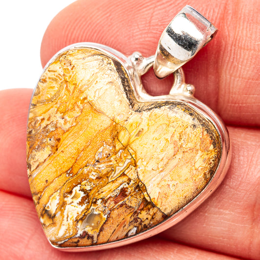 Heart-shaped sterling silver pendant with amber petrified wood inlay and bail