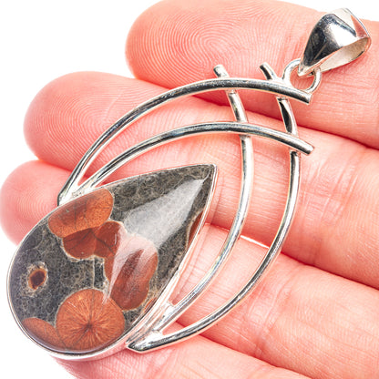 Oval Poppy Jasper pendant with sterling silver cage setting and curved hoop bail