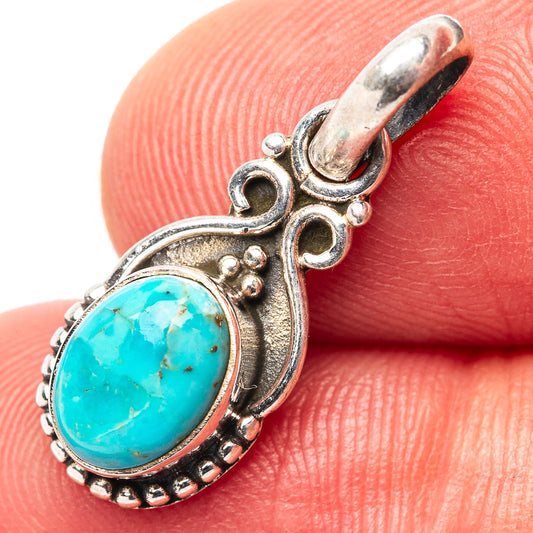 Sterling silver turquoise pendant with oval stone and scalloped bezel, bail loop top