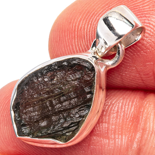 Sterling silver moldavite pendant close-up: bezel-set dark green stone