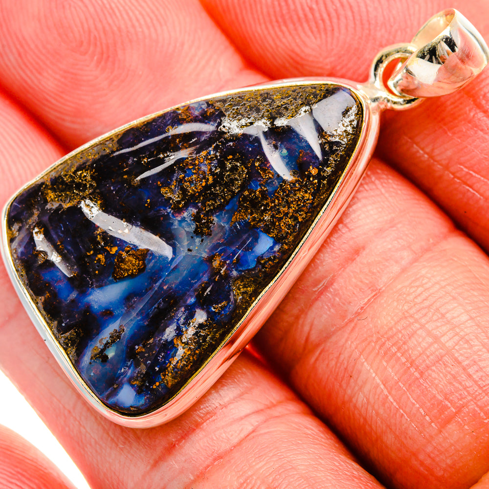 Teardrop sterling silver pendant with blue opal stone and textured gold speckles