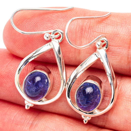 Sterling silver teardrop earrings with bezel-set blue oval gemstone and hook backs