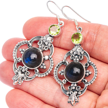 Ornate sterling silver drop earrings with blue labradorite center and green peridot top stones