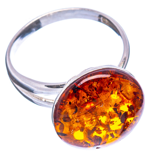 Round amber cabochon ring on silver band, warm orange-gold translucent stone