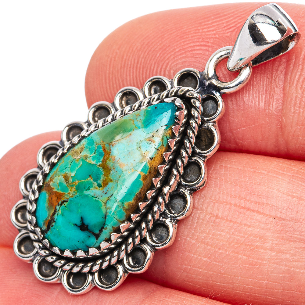 Turquoise teardrop pendant in ornate sterling silver setting, on silver bail