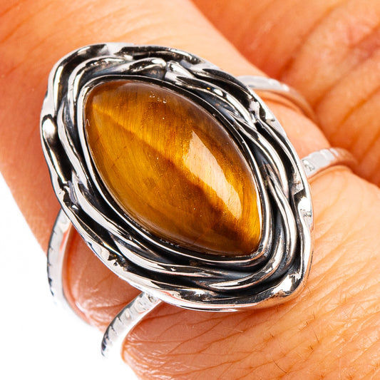 Tiger's eye oval sterling silver ring with ornate, ridged bezel frame
