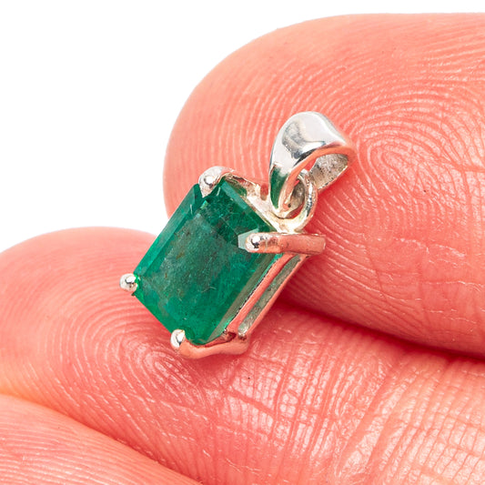 Sterling silver emerald pendant close-up showing green gemstone and loop bail