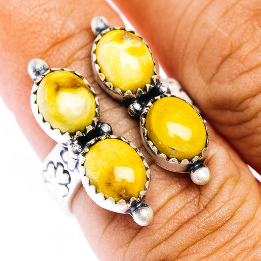 Sterling silver ring with four oval yellow cabochon stones and bead prongs