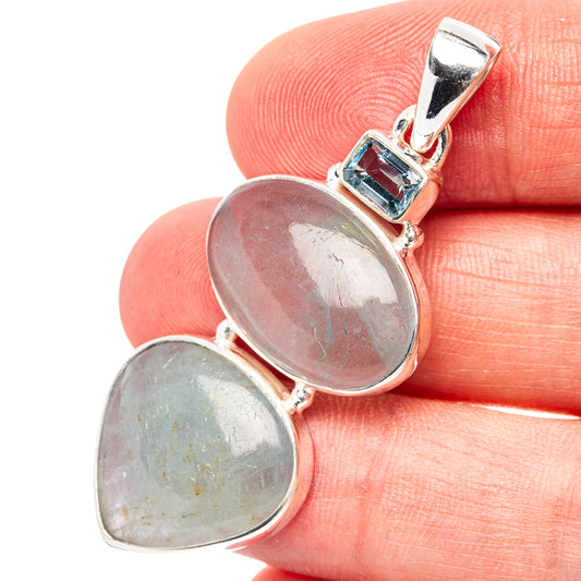 Sterling silver pendant with two oval gemstones and small blue topaz accent in bezel