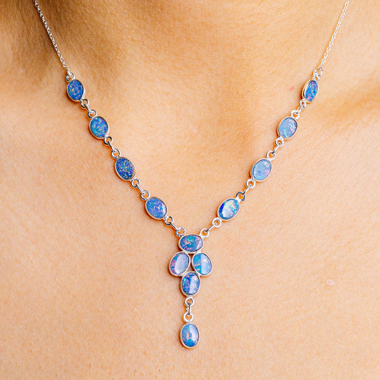 Sterling silver necklace with blue opal-like oval stones and dangling pendant