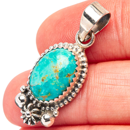 Sterling silver turquoise oval pendant with bail, beadwork edge, and stamped floral details