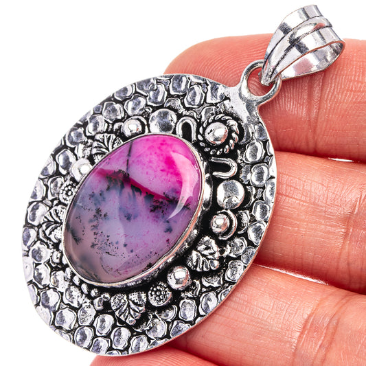 Pink oval dendritic opal pendant with ornate German-silver setting and bail