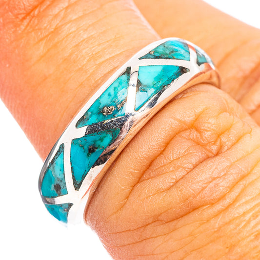 Sterling silver ring with turquoise inlay and cutout pattern, close-up on finger