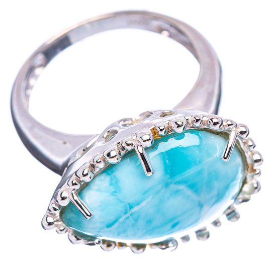 Larimar gemstone ring with oval blue-green stone, silver band, and bead-like bezel edge