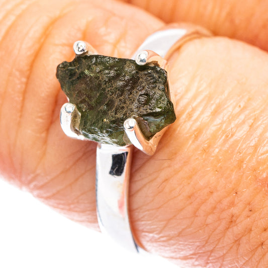 Sterling silver ring with raw green moldavite stone in three-prong setting