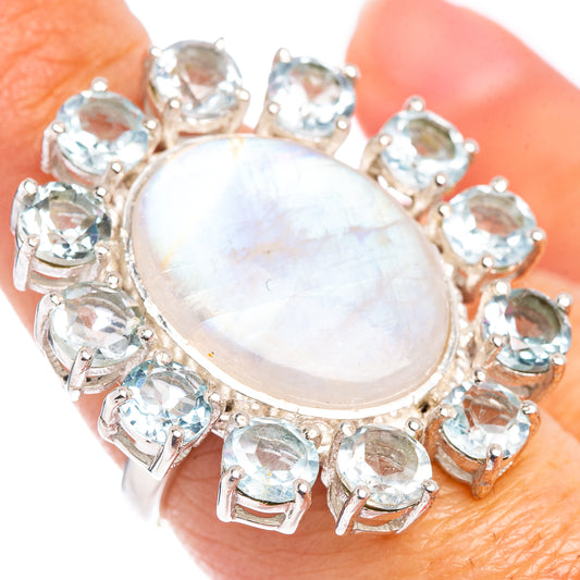 Silver ring with oval moonstone center and blue gemstone side stones, prong setting