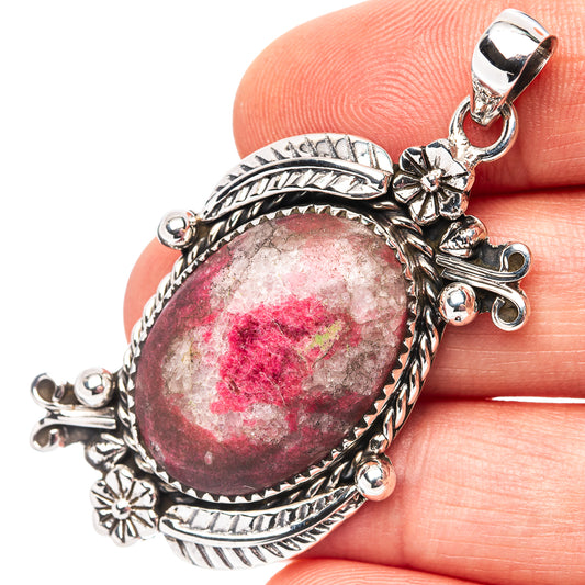 Oval pink-red thulite cabochon sterling silver pendant with ornate floral accents