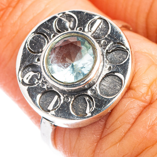 Sterling silver ring with round light-blue gemstone and ornate bezel
