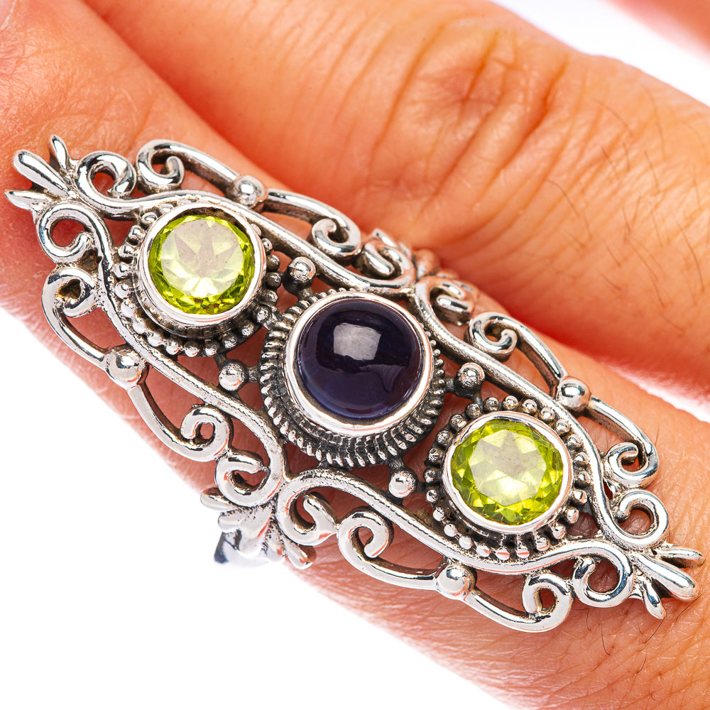 Sterling silver ring size 9.5 on finger, filigree with green stones and blue centerpiece