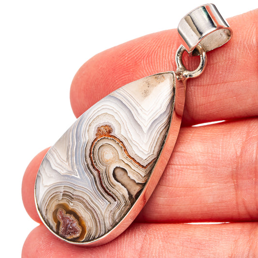 Sterling silver teardrop agate pendant with layered lace pattern, hinged bail