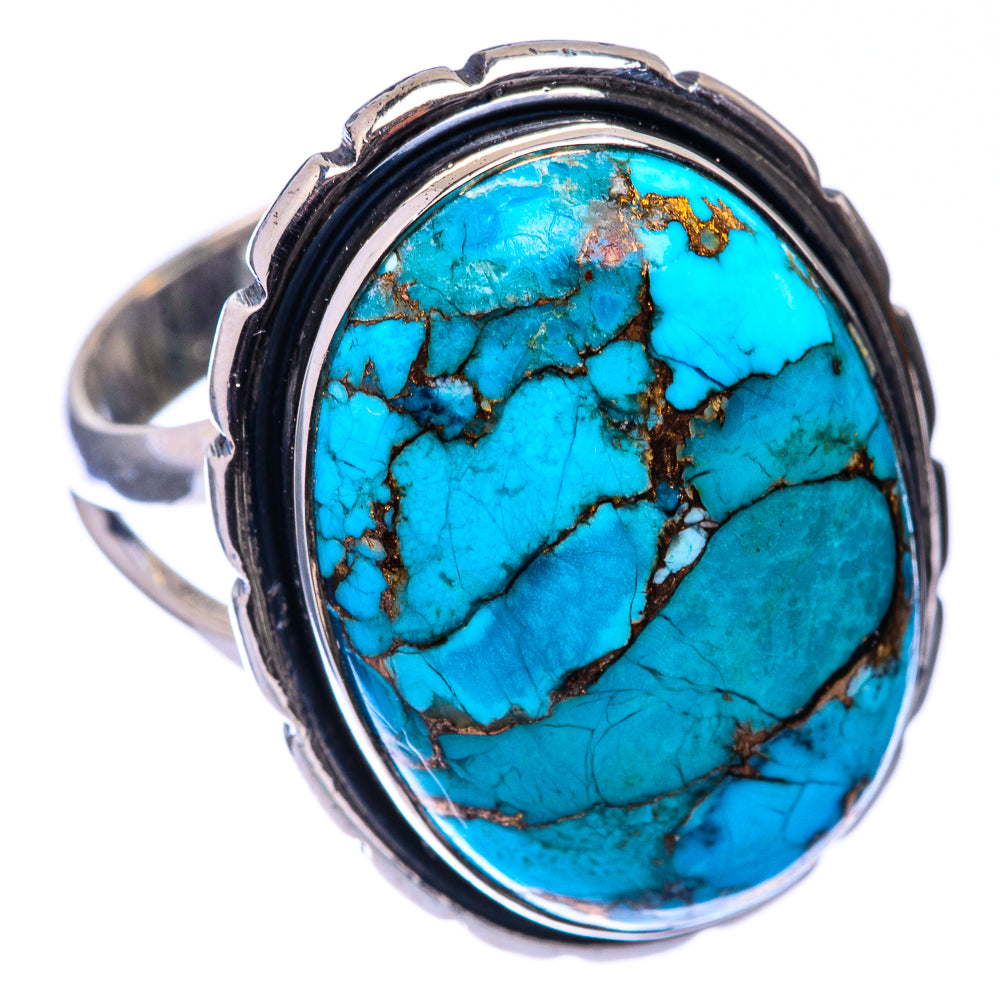 Turquoise oval cabochon silver ring with black bezel and copper vein details