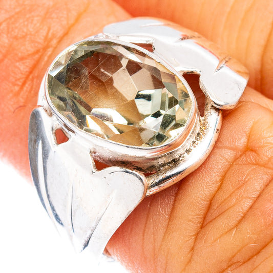 Sterling silver ring with faceted oval gemstone, heart-shaped side accents, size 4