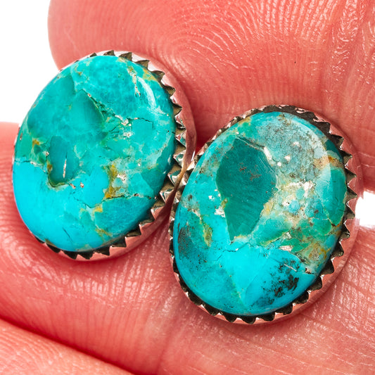 Turquoise stud earrings with serrated .925 sterling silver bezel, oval stone close-up.