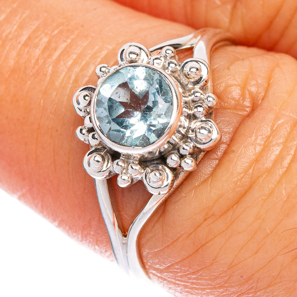 Sterling silver dainty ring with oval blue topaz and ornate scroll filigree setting