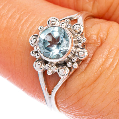 Sterling silver dainty ring with oval blue topaz and ornate scroll filigree setting
