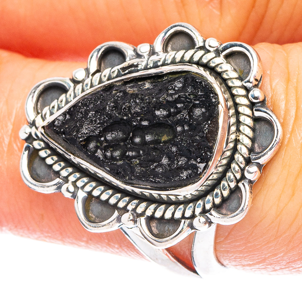 Sterling silver ring with oval black tektite stone and decorative bead-like border
