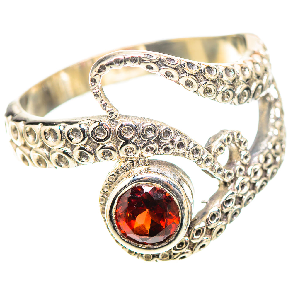 Sterling silver openwork ring with red round gemstone and curled filigree detail