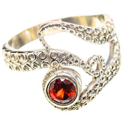 Sterling silver openwork ring with red round gemstone and curled filigree detail