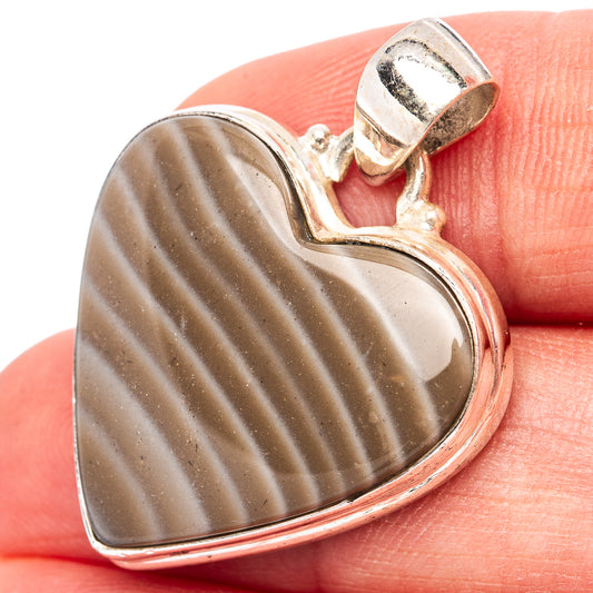 Heart-shaped sterling silver flint pendant with striped brown-gray stone and bail