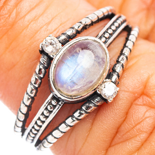 Sterling silver ring with oval rainbow moonstone bezel, beadwork, and side accents