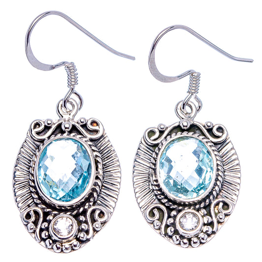 Sterling silver blue topaz dangle earrings with oval faceted stone and bezel filigree