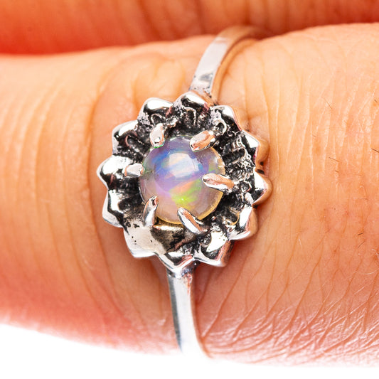 Sterling silver opal ring with oval iridescent opal center in ornate prongs