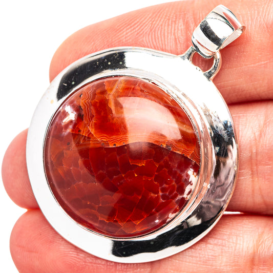 Round fire crab agate pendant in polished .925 sterling silver bezel, red stone