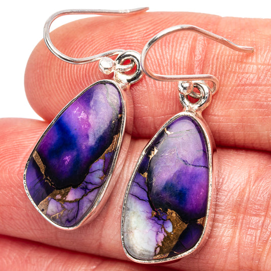 Sterling silver teardrop earrings with purple-blue gemstone drops and gold veining.