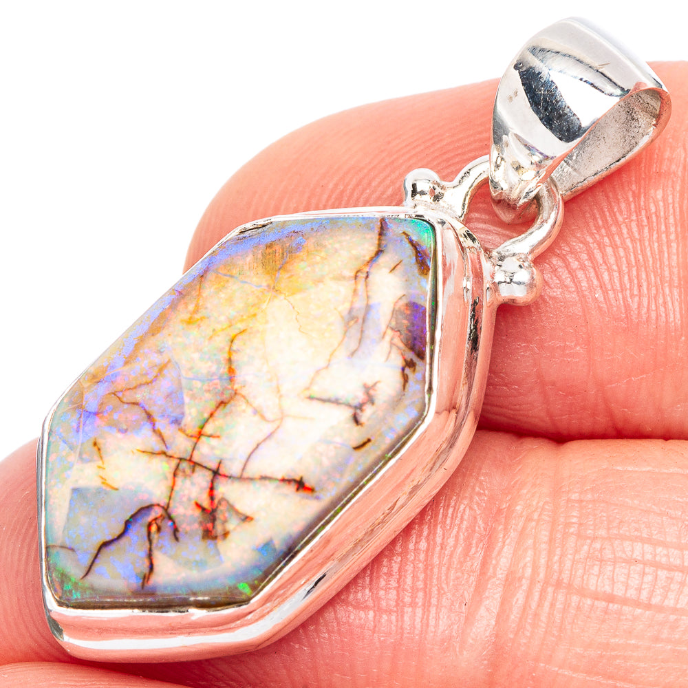Sterling silver opal pendant with teardrop bezel and multicolor stone, bail visible