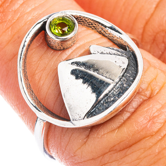 Sterling silver peridot ring with round green gemstone and shield-heart detail