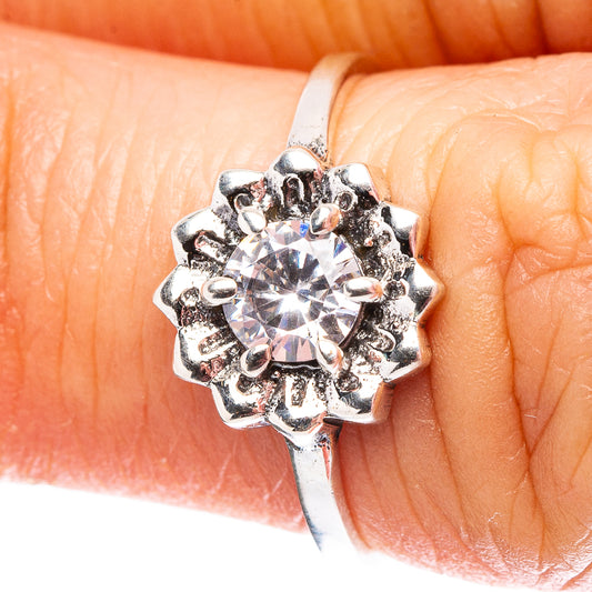 Sterling silver cubic zirconia ring on finger, round center stone in spiky halo